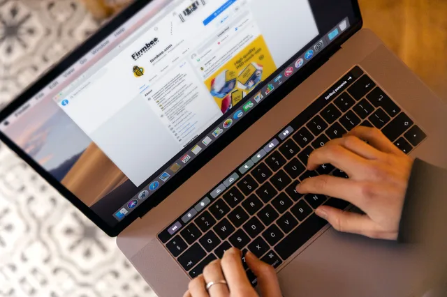 Hands typing on a laptop at a desk, engaging in online work, and navigating social media. Hotel Email Marketing: A Practical Method